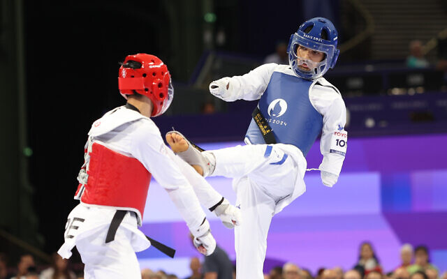 Israeli taekwondo athlete Asaf Yasur (blue) competes at the 2024 Paris Paralympics on August 29, 2024. (Lilach Weiss-Rosenberg)