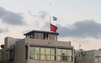 A drone carries an Israeli flag above the Turkish flag, which is lowered to half-mast in a show of mourning for slain Hamas leader Ismail Haniyeh, over Turkey's embassy in Tel Aviv, August 2, 2024. (Screen capture: Ynet, used in accordance with Clause 27a of the Copyright Law)