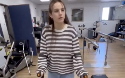 Maya Regev, 21, is seen taking her first steps with crutches after nine months of recovery following her abduction and captivity by Hamas terrorists, who shot her on October 7 during the group's attack on southern Israel, in a video posted to social media. (Screen capture via X, used in accordance with Clause 27a of the Copyright Law)