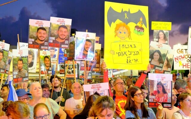 Protesters hold up images of the Gaza hostages as they call for the government to finalize a deal with Hamas for their release, at Tel Aviv's Hostages Square, August 10, 2024. (Adar Eyal/Pro-Democracy Protest Movement) Protesters hold up images of the Gaza hostages as they call for the government to finalize a deal with Hamas for their release, at Tel Aviv's Hostages Square, August 10, 2024. (Adar Eyal/Pro-Democracy Protest Movement)