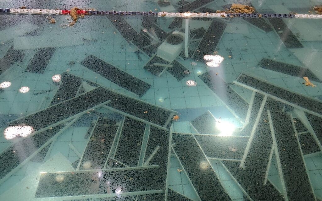 Ceiling panels, which were dislodged from the roof due to a rocket impact, seen on the bottom of the hydrotherapy pool at the Mevo'ot HaHermon Treatment and Rehabilitation Campus, on August 13, 2024. (Gavriel Fiske/TOI)