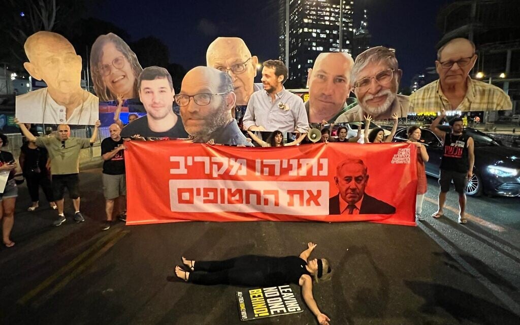 Protesters hold images of six hostages whose bodies were recovered from Gaza overnight at a protest in Tel Aviv demanding a hostage deal, August 20, 2023. (Yael Gadot / Pro-Democracy Protest Movement