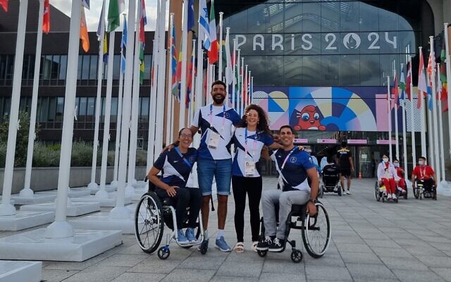 Israeli Paralympic rowers (from left) Moran Samuel, Saleh Shahin, Shahar Milfelder and Shmulik Daniel pose for a photo at the Paris Paralympics on August 22, 2024. (Reuven Magnagey)