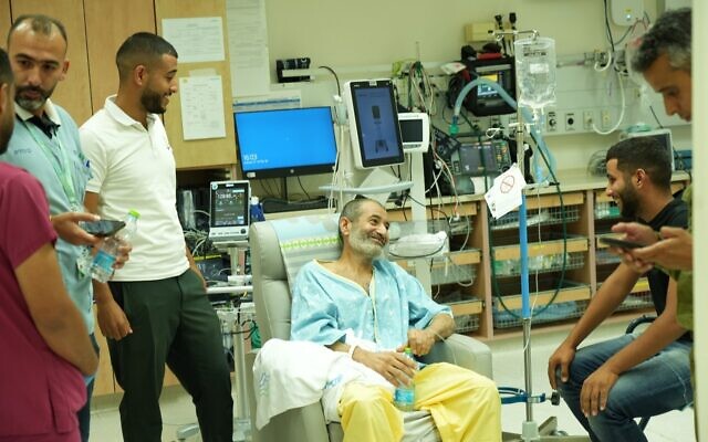 Rescued hostage Farhad al-Qadi (center) reunites with family members at Soroka Medical Center in Beersheba on August 27, 2024. (Yossi Ifergan/GPO)