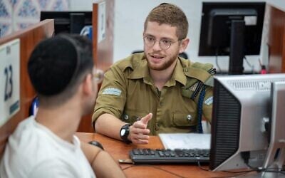 A Haredi draftee is received by a soldier at the Tel Hashomer base in central Israel, August 6, 2024. (Israel Defense Forces)