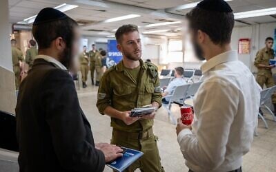 Ultra-Orthodox men at the Tel Hashomer military recruitment office, August 6, 2024. (Israel Defense Forces)