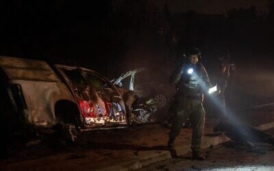 IDF troops examine the wreckage of a car bomb in the West Bank settlement of Karmei Tzur, early August 31, 2024. (Israel Defense Forces)