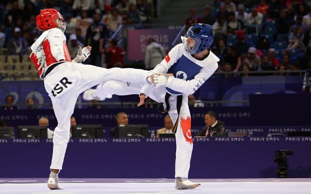 Israeli taekwondo athlete Adnan Milad (red) competes against Turkey's Mahmut Bozteke in the men's under-63kg tournament at the 2024 Paris Paralympics on August 30, 2024. (Keren Isaacson) Israeli taekwondo athlete Adnan Milad (red) competes against Turkey's Mahmut Bozteke in the men's under-63kg tournament at the 2024 Paris Paralympics on August 30, 2024. (Keren Isaacson)