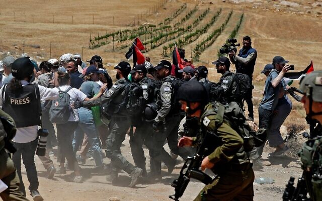 Israeli security forces try to disperse Palestinian, left-wing Israeli and foreign activists, during a protest near the West Bank Israeli settlement of Mitzpe Yair in Masafer Yatta near Hebron on June 10, 2022. (Ahmad Gharabli/AFP via Getty Images, via JTA) Israeli security forces try to disperse Palestinian, left-wing Israeli and foreign activists, during a protest near the West Bank Israeli settlement of Mitzpe Yair in Masafer Yatta near Hebron on June 10, 2022. (Ahmad Gharabli/AFP via Getty Images, via JTA)