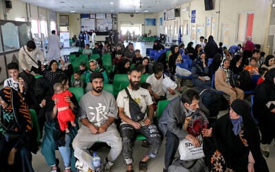 Afghan refugees wait for registration after their deportation from Iran, at a registration center near the Afghanistan-Iran border in the Islam Qala district of Herat province, Sep. 12, 2024. (Mohsen KARIMI / AFP)
