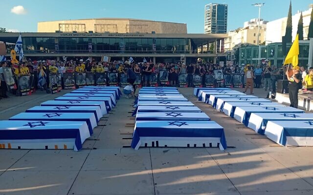 Protesters demanding a deal freeing hostages in Gaza gather around 27 mock coffins at Tel Aviv's Habima Square on September 5, 2024. (Noam Lehmann/Times of Israel)