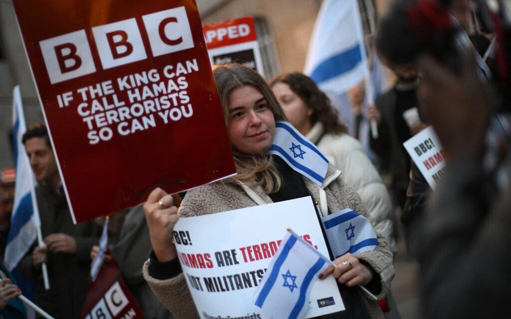 Illustrative: Protesters holding placards and Israeli flags join a gathering outside the headquarters of the BBC (British Broadcasting Corporation) in London on October 16, 2023, to appeal to the corporation to call Hamas 'terrorists.' (Daniel Leal/AFP) Illustrative: Protesters holding placards and Israeli flags join a gathering outside the headquarters of the BBC (British Broadcasting Corporation) in London on October 16, 2023, to appeal to the corporation to call Hamas 'terrorists.' (Daniel Leal/AFP)