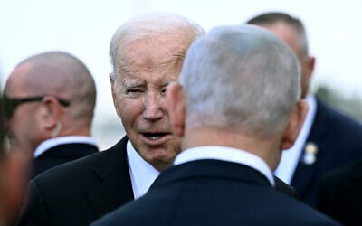 Israel Prime Minister Benjamin Netanyahu (back) greets US President Joe Biden upon his arrival at Tel Aviv's Ben Gurion airport on October 18, 2023, amid the ongoing battles between Israel and the Palestinian group Hamas. Biden landed in Israel on October 18, on a solidarity visit following Hamas attacks that have led to major Israeli reprisals. (Brendan Smialowski/AFP)
