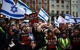 Protesters hold placards and wave Israeli flags as they take part in a demonstration outside the BBC headquarters, in London, on February 4, 2024, to bring attention to the plight of kidnapped Israeli women in Gaza. (HENRY NICHOLLS / AFP)