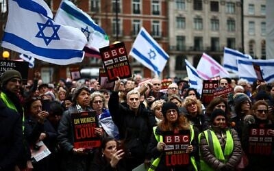 Protesters hold placards and wave Israeli flags as they take part in a demonstration outside the BBC headquarters, in London, on February 4, 2024, to bring attention to the plight of kidnapped Israeli women in Gaza. (HENRY NICHOLLS / AFP)
