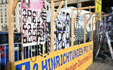 Portraits are exhibited behind a noose as a placard reads, 'Executions pro day,' in front of the Brandenburg Gate during a demonstration by supporters of the National Council of Resistance of Iran in Berlin, Germany on February 10, 2024. (STEFANIE LOOS / AFP)