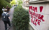Illustrative: Graffiti reading 'From the river to the sea' is seen on a building adjacent to an encampment protesting the University of Washington's ties to Israel and Boeing on the university's campus in Seattle, Washington, May 12, 2024. (Jason Redmond / AFP)