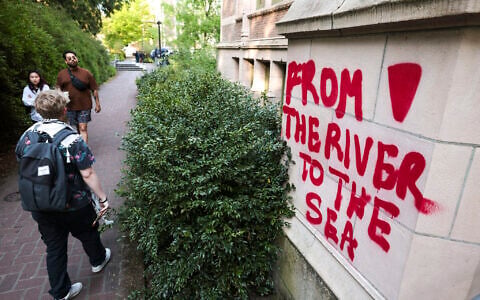 Illustrative: Graffiti reading 'From the river to the sea' on a building adjacent to an encampment at the University of Washington, in Seattle, Washington, May 12, 2024. (Jason Redmond / AFP)