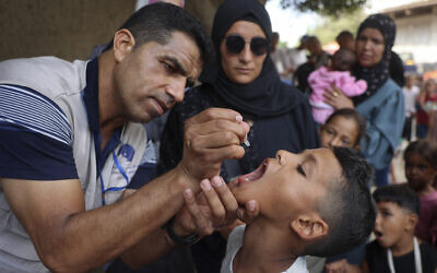 A health worker administers the polio vaccine to a Palestinian child in Zawayda in the central Gaza Strip on September 1, 2024. (Eyad Baba/AFP)