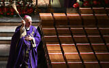 A Catholic priest conducts a funeral service for remains of over 700 victims of German crimes of the World War II, discovered in the so-called Valley of Death, at the Minor Basilica of the Holy Trinity of St. John the Baptist in Chojnice, Poland, on September 2, 2024. (Sergei GAPON / AFP)