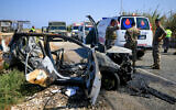 Lebanese security forces and rescue teams inspect a charred car that was hit by an Israeli drone strike near Naqoura on the border with Israel on September 2, 2024. (AFP)