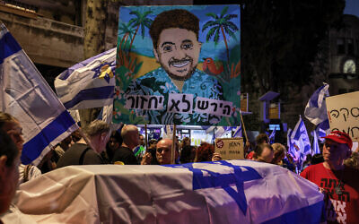 Demonstrators gather for an anti-government protest calling for action to release the hostages held captive since the October 7 attacks by Palestinian terrorists in the Gaza Strip and for a deal to release them, near the Prime Minister's residence in Jerusalem on September 2, 2024. Banner reads 'Hersh won't come home.' (Menahem Kahana / AFP)