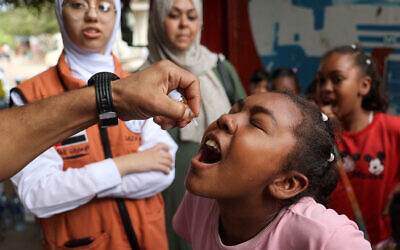 A child receives a vaccination for polio in Deir el-Balah in the central Gaza Strip on September 4, 2024. (Eyad BABA / AFP)