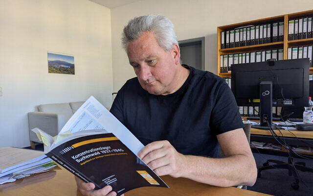 Historian Jens-Christian Wagner looks into a book on September 2, 2024, in Buchenwald, near Weimar, eastern Germany. (Clement Kasser/AFP) Historian Jens-Christian Wagner looks into a book on September 2, 2024, in Buchenwald, near Weimar, eastern Germany. (Clement Kasser/AFP)