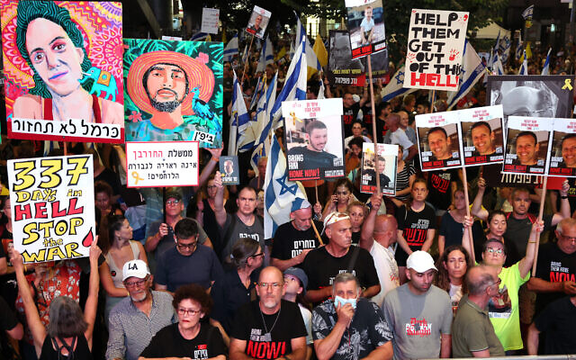 Demonstrators raise placards and Israeli flags during an anti-government protest calling for action to secure the release of hostages held captive since Hamas's October 7 massacre, Tel Aviv, September 7, 2024. (Jack Guez/AFP) Demonstrators raise placards and Israeli flags during an anti-government protest calling for action to secure the release of hostages held captive since Hamas's October 7 massacre, Tel Aviv, September 7, 2024. (Jack Guez/AFP)
