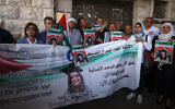 Palestinian activists lift a banner and portraits of slain Turkish-American International Solidarity Movement activist Ayşenur Ezgi Eygi during a funeral procession in the West Bank city of Nablus, September 9, 2024. (Jaafar Ashtiyeh/AFP)
