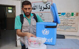 A Palestinian medic unpacks polio vaccines during an inoculation drive at the al-Daraj neighborhood clinic in Gaza City on September 10, 2024. (Omar AL-QATTAA / AFP)
