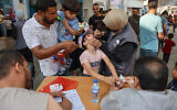 Palestinian medics administer polio vaccines to children at the al-Daraj neighborhood clinic in Gaza City on September 10, 2024. (Omar Al-Qattaa/AFP)