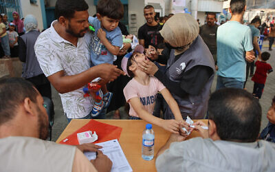 Palestinian medics administer polio vaccines to children at the al-Daraj neighborhood clinic in Gaza City on September 10, 2024. (Omar Al-Qattaa/AFP)