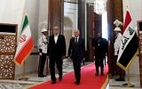 This handout photograph released by the Iraqi President's Office shows Iraq's President Abdul Latif Rashid, right, welcoming his counterpart from Iran Masoud Pezeshkian in Baghdad on September 11, 2024. (Iraqi Presidency Media Office / AFP)
