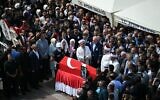 Relatives and officials look at the coffin of Turkish-American activist Aysenur Ezgi Eygi, who the IDF says was likely shot dead inadvertently by Israeli forces while protesting against Israeli settlements in the West Bank, during her funeral ceremony at the Didim central mosque in Aydin Province on September 14, 2024. (OZAN KOSE / AFP)