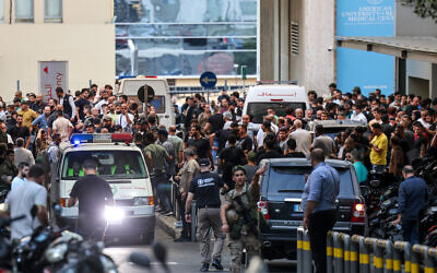 Ambulances are surrounded by people at the entrance of the American University of Beirut Medical Center, in Lebanon, on September 17, 2024. (Anwar AMRO / AFP)