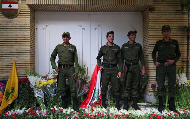 Iranian security forces stand at the site of a memorial set up outside Lebanon's embassy in Tehran, Iran, on September 18, 2024. (ATTA KENARE / AFP)