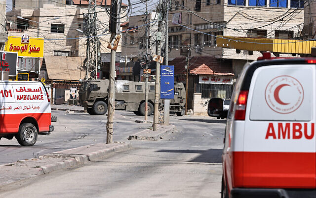 Palestinian Red Crescent ambulances and Israeli army vehicles during an Israeli military raid in Qabatiyah in the north of the West Bank, on September 19, 2024. (Zain JAAFAR / AFP) Palestinian Red Crescent ambulances and Israeli army vehicles during an Israeli military raid in Qabatiyah in the north of the West Bank, on September 19, 2024. (Zain JAAFAR / AFP)