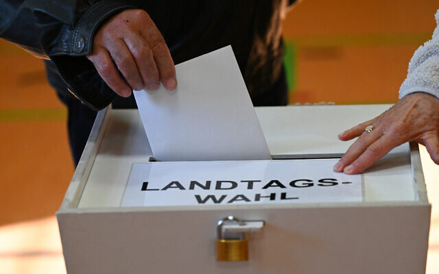 A voter casts a ballot in the ballot box during the state elections in Brandenburg in Forst on September 22, 2024. (Photo by RALF HIRSCHBERGER / AFP) A voter casts a ballot in the ballot box during the state elections in Brandenburg in Forst on September 22, 2024. (Photo by RALF HIRSCHBERGER / AFP)
