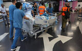 Paramedics help the medical staff at Haifa's Rambam hospital to transport patients from the upper floors to underground parking area of the establishment on September 22, 2024, after Lebanon's Hezbollah fired a barrage of rockets on northern Israel. (Jack GUEZ / AFP)