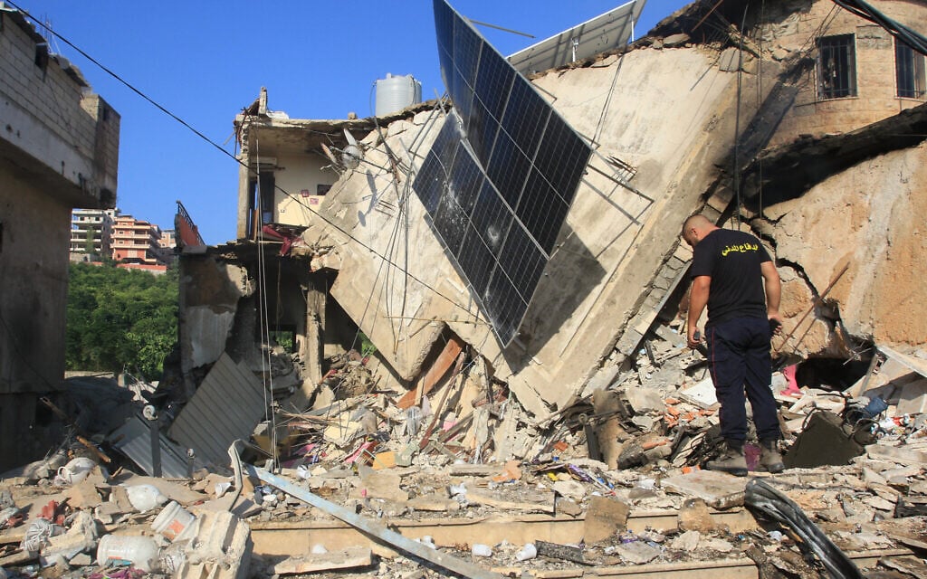 A rescuer inspects the debris at the site of an overnight Israeli strike in the southern Lebanese village of Akbiyeh on September 24, 2024 (Mahmoud ZAYYAT / AFP)