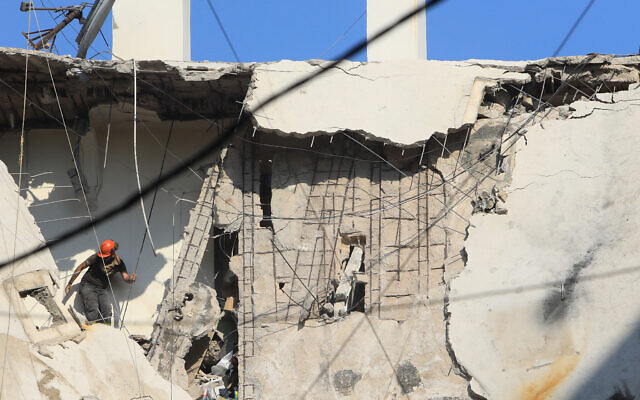 A rescuer inspects the destruction on a residential building whose top two floors were hit by an Israeli strike on Hezbollah's rocket chief in the Ghobeiri area of Beirut's southern suburbs on September 24, 2024. (AFP) A rescuer inspects the destruction on a residential building whose top two floors were hit by an Israeli strike on Hezbollah's rocket chief in the Ghobeiri area of Beirut's southern suburbs on September 24, 2024. (AFP)