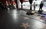 Crew members and media work near the Hollywood Walk of Fame, March 8, 2023, outside the Dolby Theatre in Los Angeles. (AP Photo/Chris Pizzello)