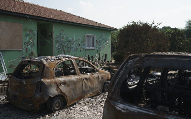 Burned cars are seen at moshav Netiv Ha'asara near the border with Gaza Strip, November 17, 2023, after the Israeli community was attacked during the Hamas cross-border onslaught on October 7, 2023. (AP Photo/Leo Correa)