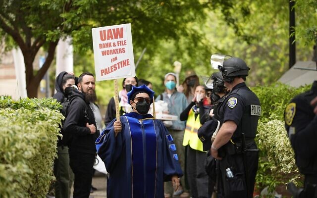 A Pro-Palestinian, anti-Israel demonstrator holds a UAW sign at the University of California Los Angeles campus on May 23, 2024, in Los Angeles. (AP Photo/Ryan Sun)