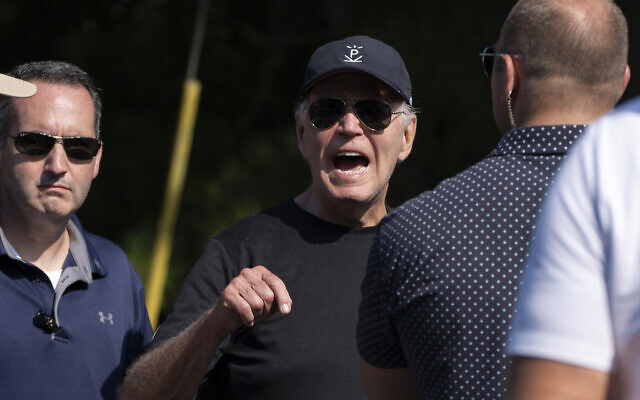 US President Joe Biden speaks to reporters as he leaves the beach in Rehoboth Beach, Delaware, August 31, 2024. (AP/Manuel Balce Ceneta)