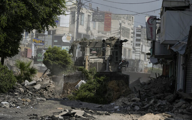 An Israeli military bulldozer tears up a road littered with rubble during an army raid in Jenin, West Bank, Sept. 2, 2024. (AP Photo/Majdi Mohammed) An Israeli military bulldozer tears up a road littered with rubble during an army raid in Jenin, West Bank, Sept. 2, 2024. (AP Photo/Majdi Mohammed)