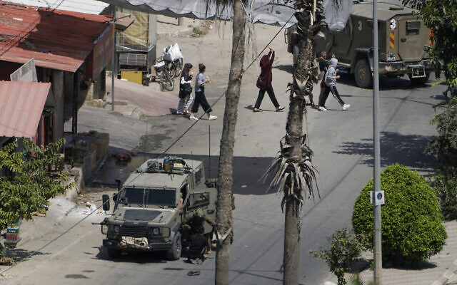 Israeli soldiers arrest a Palestinian man as others walk by with their hands up during a military operation in Jenin, West Bank, Sept. 5, 2024. (AP Photo/Majdi Mohammed) Israeli soldiers arrest a Palestinian man as others walk by with their hands up during a military operation in Jenin, West Bank, Sept. 5, 2024. (AP Photo/Majdi Mohammed)