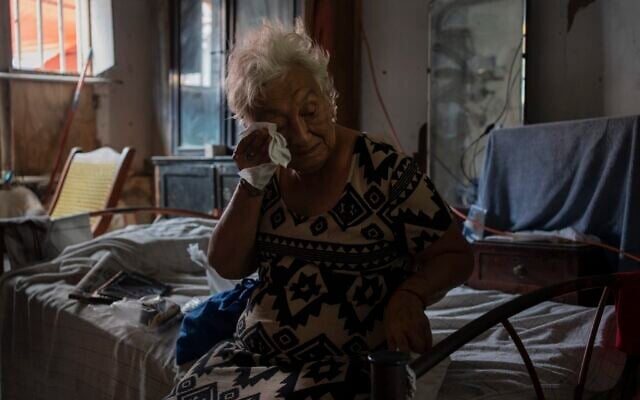 Margarita Salazar, 82, wipes the sweat off with a tissue inside her home in Veracruz, Mexico on June 16, 2024. (AP Photo/Felix Marquez, File)