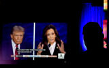 A man watches the presidential debate between Republican presidential nominee former President Donald Trump and Democratic presidential nominee Vice President Kamala Harris at a 97-year-old movie theater Tuesday, Sept. 10, 2024, in Shawnee, Kansas. (AP/Charlie Riedel)
